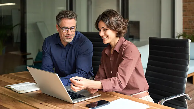 Man and Woman on laptop happy